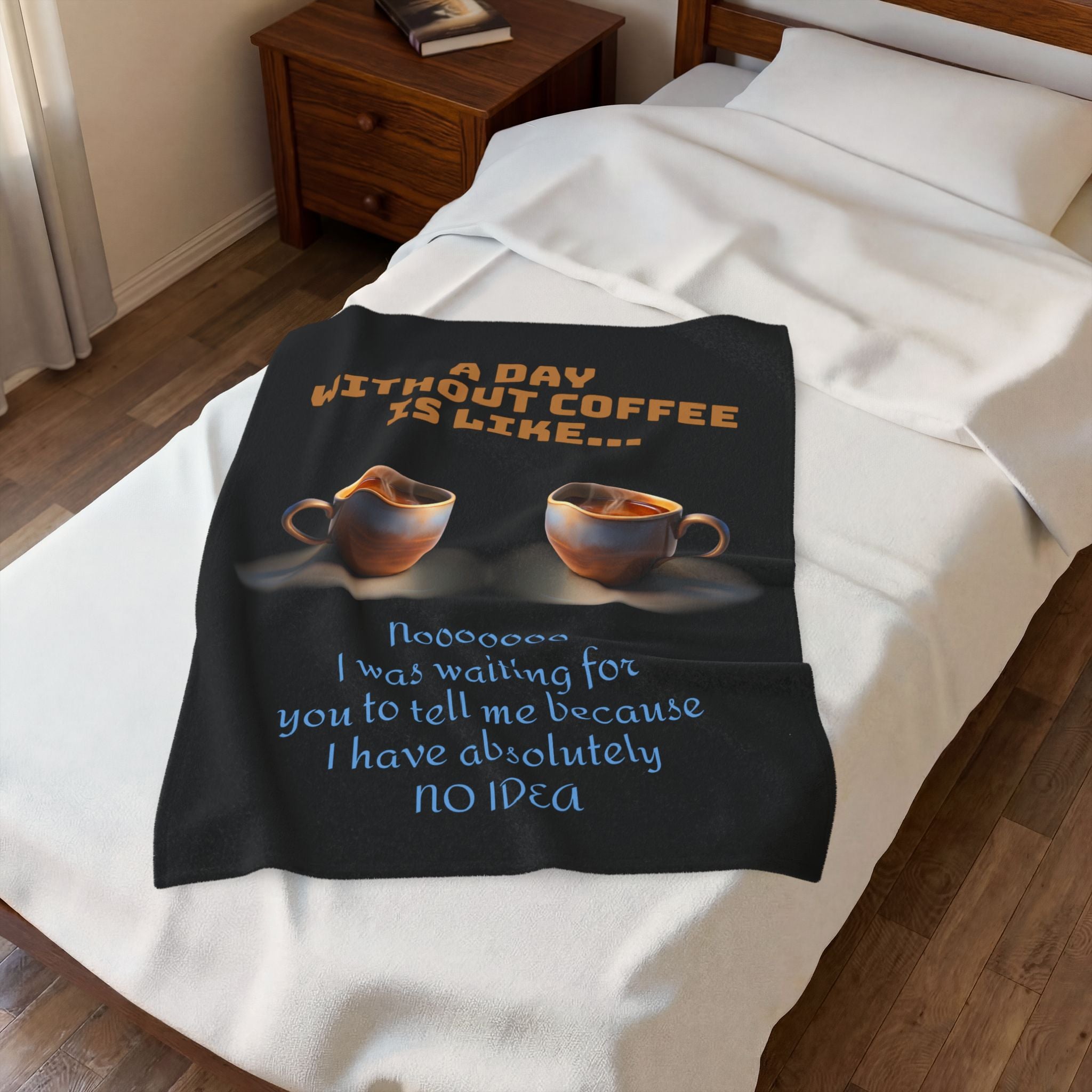 Black blanket with coffee-themed text on a bed in a bedroom.