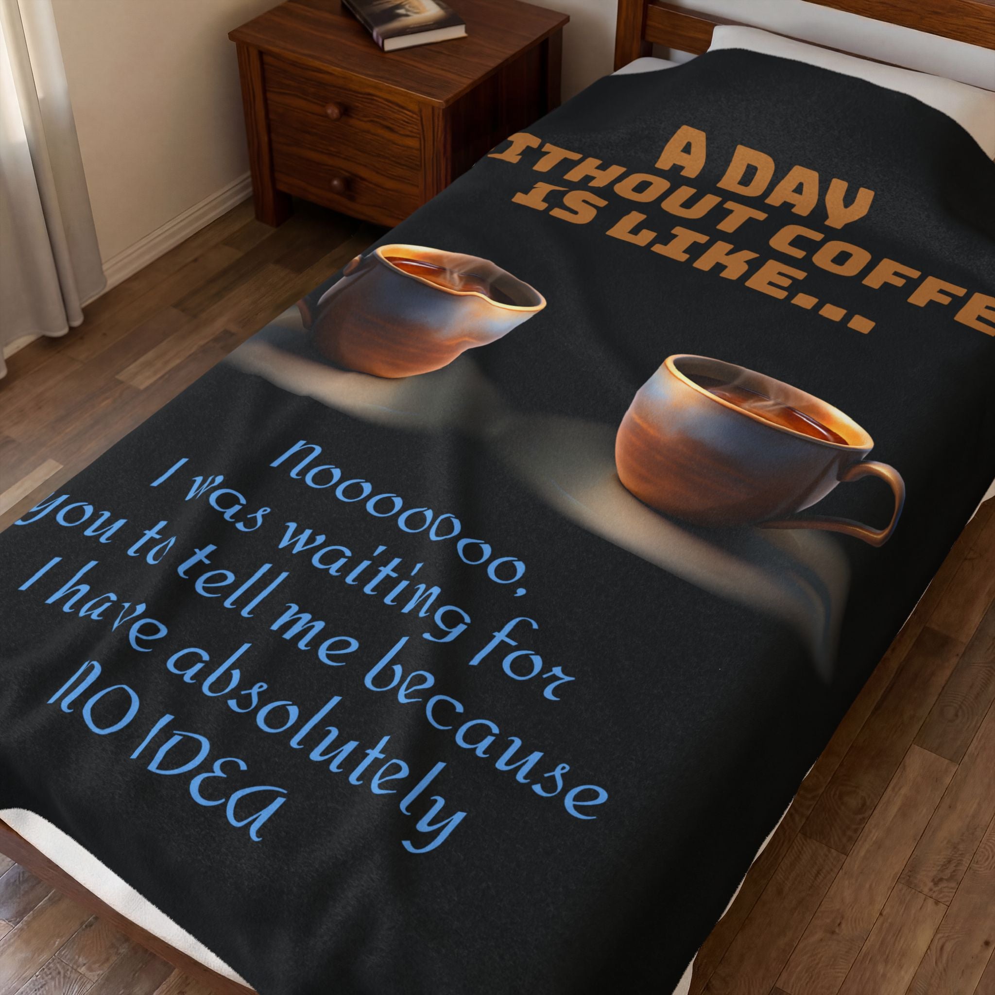 Black blanket with coffee-themed text and cups on a bed in a bedroom.