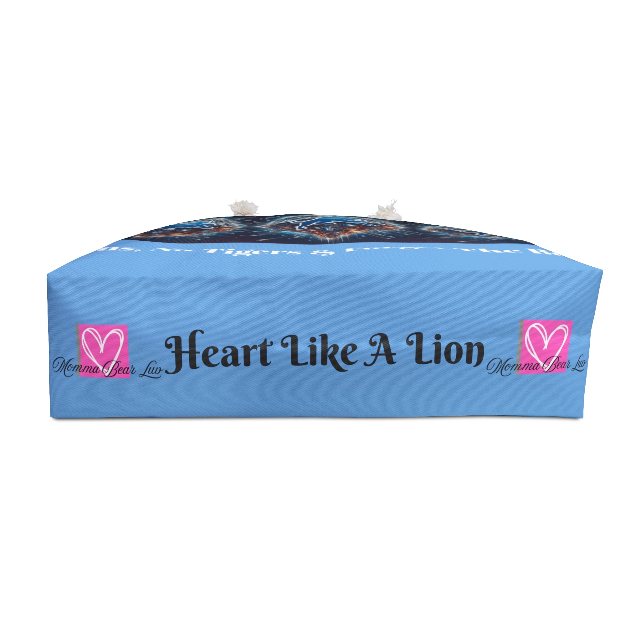 Blue pillow with 'Heart Like A Lion' text and logo on a white background