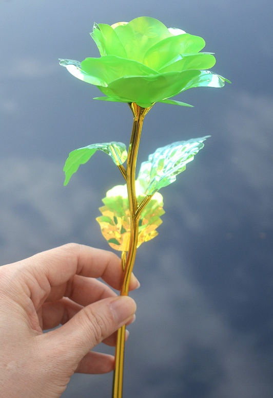 Decorative green flower gold dipped stem. Plastic.
