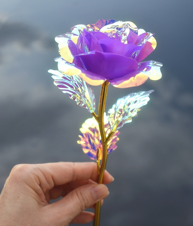 Decorative purple gold stemmed rose with holographic leaves. Plastic.