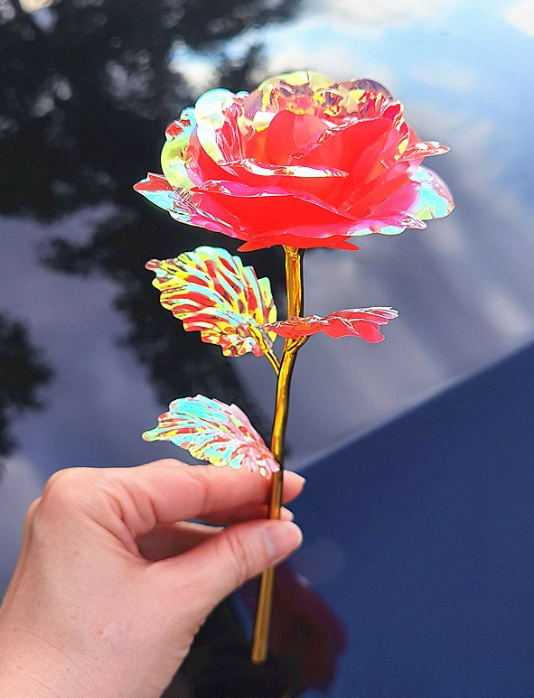 Decorative red flower with gold dipped stem.  Plastic.