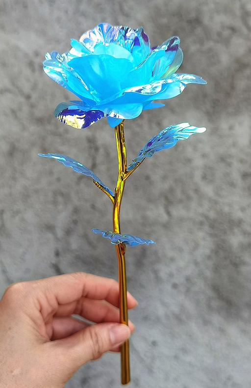 Decorative blue flower with gold dipped stem. Plastic.