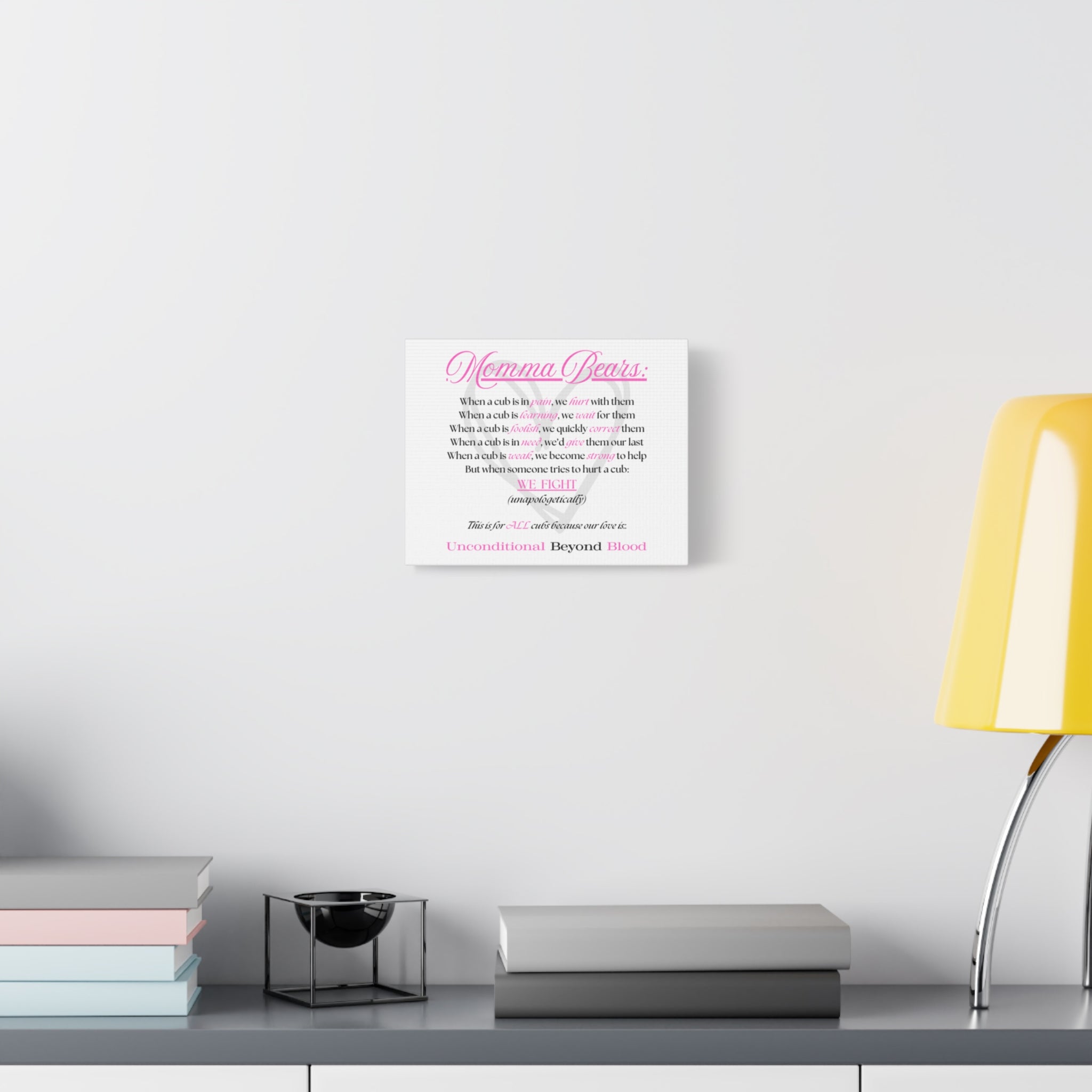 White box with a logo on a white surface next to a yellow lamp and books.