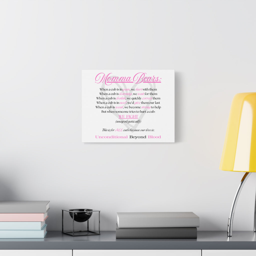 Framed artwork with 'Simply Iconic' text on a wall above a desk with books and a lamp.