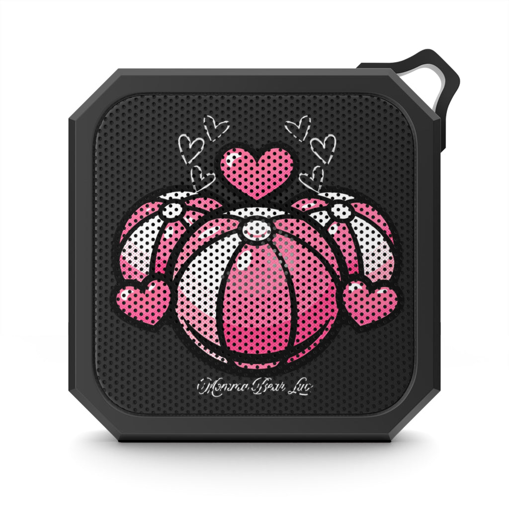Black portable speaker with pink and white beach balls and hearts design.