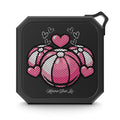 Black portable speaker with pink and white beach balls and hearts design.