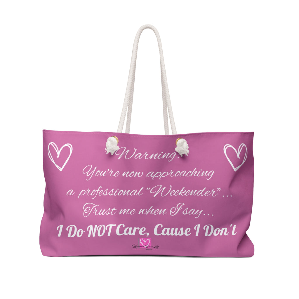 Pink tote bag with humorous text.