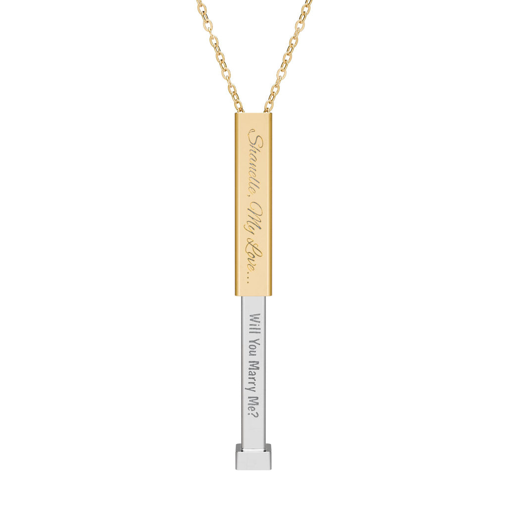 Gold secret proposal necklace with a silver insert bar engraved with words "Will You Marry Me?" on it. 